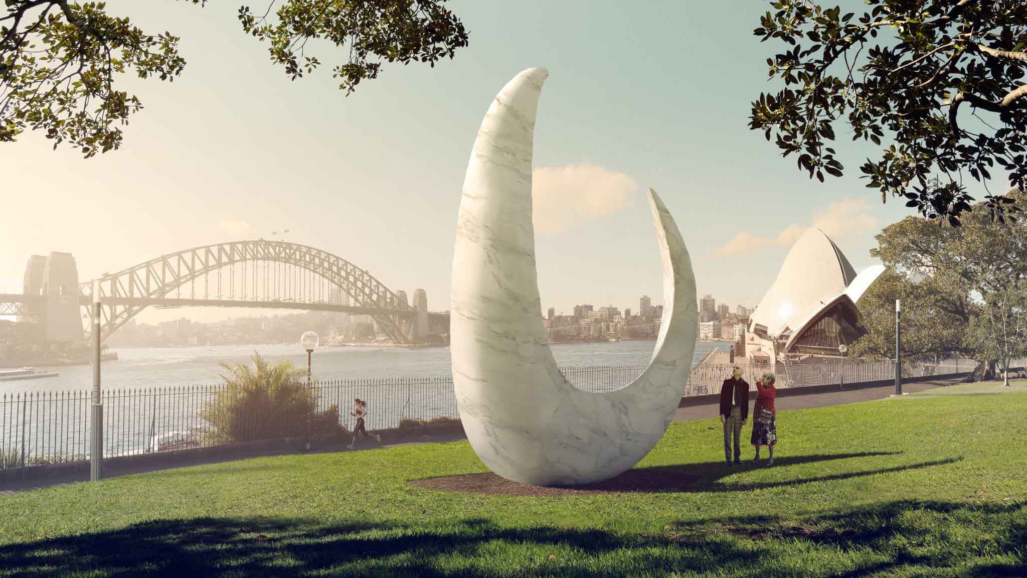 Large white sculpture on a green lawn in a park being viewed by two people. In the background is a harbour, bridge and city buildings.